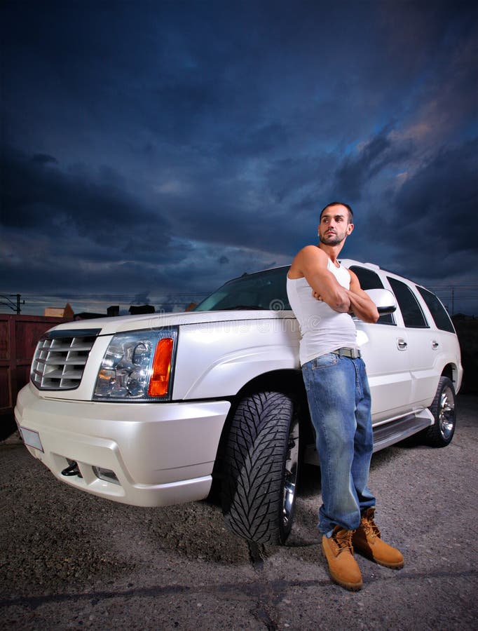 Person standing next to an SUV stock photography