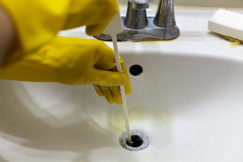 https://thumbs.dreamstime.com/b/person-trying-to-unclog-drain-sink-using-plastic-disposable-snake-auger-tool-which-helps-pull-hair-soap-debris-213935587.jpg