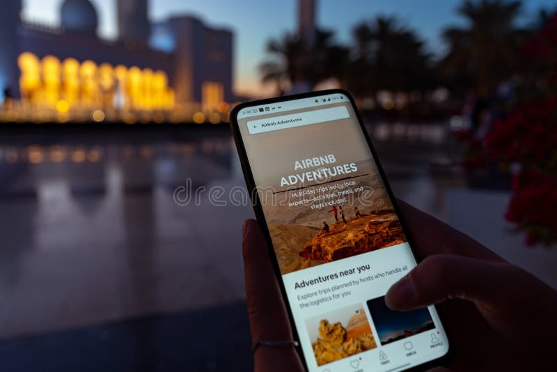 A Person Using the Airbnb App on a Smartphone  Exploring Travel Destinations  Airbnb 