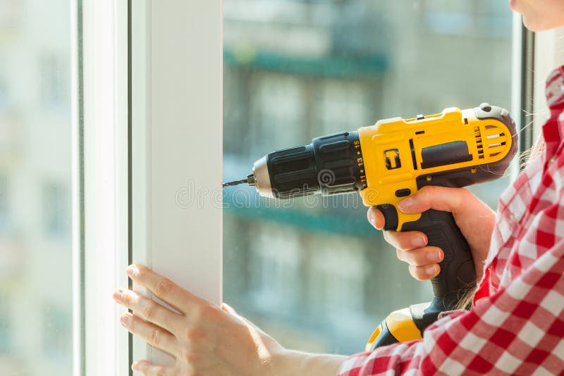 Person Using Drill on Window Stock Photo - Image of repair, tools: 134791740