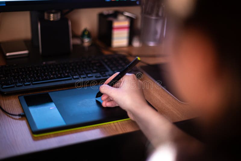 A Person Using Graphic Tablet with Pen and Working on New Project Idea