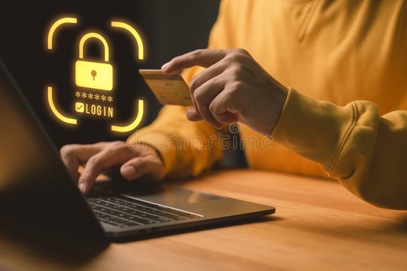 Person using a laptop computer and credit card with security shield, representing online payment protection royalty free stock photography