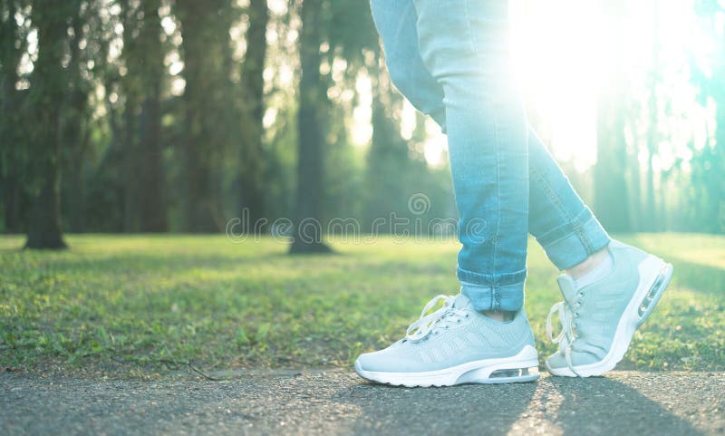 Person walking in gray running shoes, closeup
