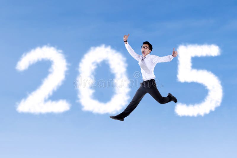 Persona que lleva el traje formal que forma el número 2015 foto de archivo libre de regalías Persona que lleva el traje formal que forma el número 2015 foto de archivo libre de regalías