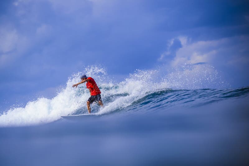 Persona que practica surf en onda azul asombrosa foto de archivo Persona que practica surf en onda azul asombrosa foto de archivo