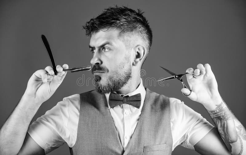 Personal care. Bearded mature hipster hold shaving blade. unshaven barber in tie. perfect beard. Male fashion stock images Personal care. Bearded mature hipster hold shaving blade. unshaven barber in tie. perfect beard. Male fashion stock images