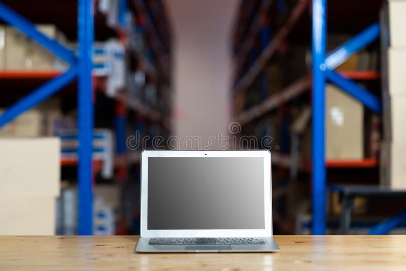 Personal Laptop Computer in Warehouse Store. Warehouse with Rows of