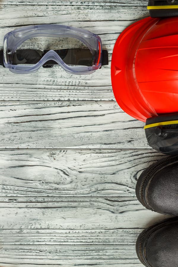 Personal Protective Equipment: Black Gloves Goggles Glasses on a Wooden