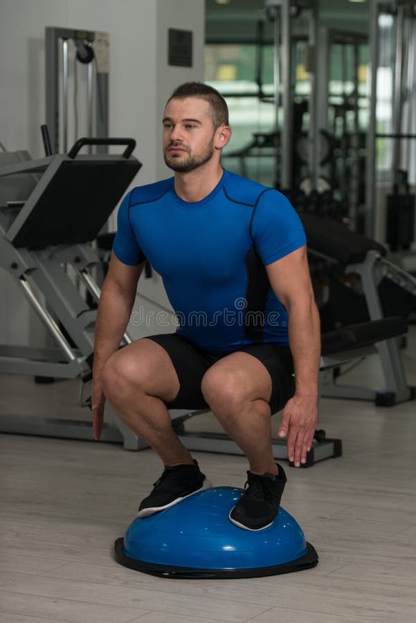 Personal Trainer Doing Exercise on Bosu Balance Ball Stock Image Image of determination