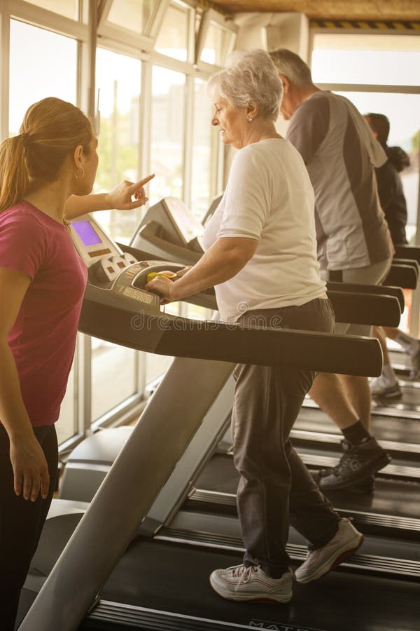 Personal trainer exercise helps elderly couple. Senior couple on stock photos Personal trainer exercise helps elderly couple. Senior couple on stock photos