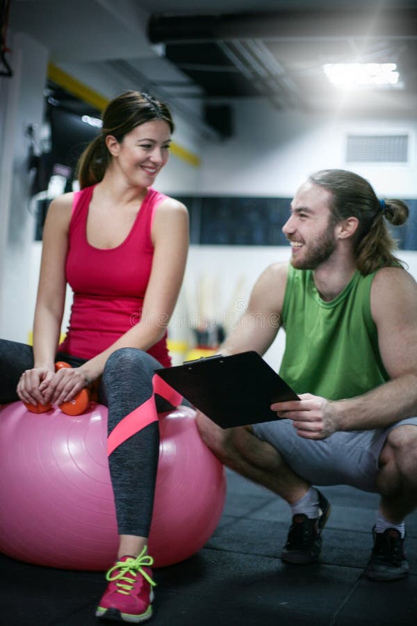 Personal trainer having a training consultation with a client. T stock image Personal trainer having a training consultation with a client. T stock image