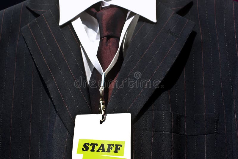 Staff member concept: staff label on badge and business suit. Staff member concept: staff label on badge and business suit