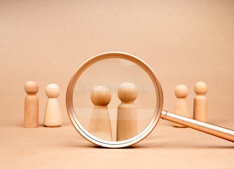 Human resource (HR), hiring, couple, partner selection, recruitment, love calculator match, online dating concepts. Male and female wooden figures were chosen in magnifying lens on beige background. Human resource (HR), hiring, couple, partner selection, recruitment, love calculator match, online dating concepts. Male and female wooden figures were chosen in magnifying lens on beige background.