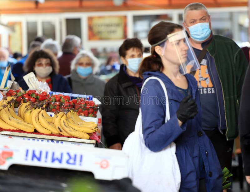 People wearing face masks and gloves for prevention of coronavirus COVID-19 on a marketplace in Sofia, Bulgaria on 04/14/2020. People wearing face masks and gloves for prevention of coronavirus COVID-19 on a marketplace in Sofia, Bulgaria on 04/14/2020.