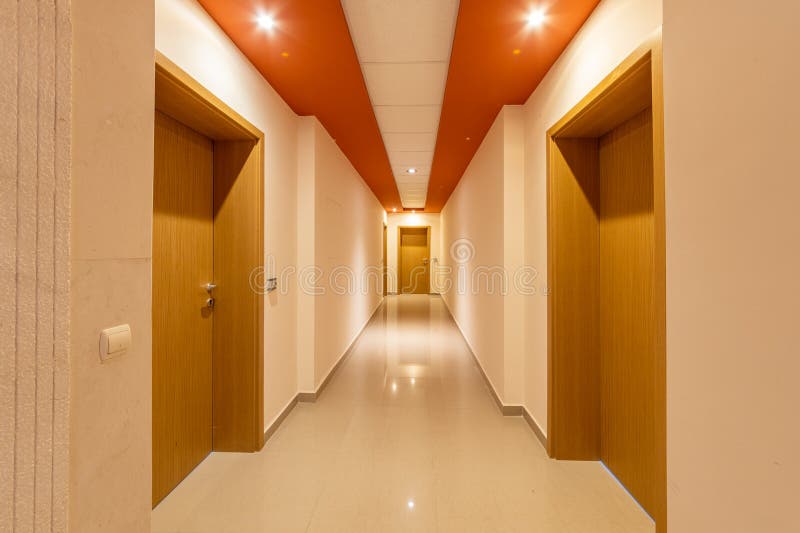 Perspective Corridor of Condominium. Modern and Bright Interior in the Hotel. Long Hallway with