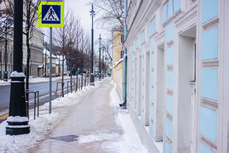 Perspective pathway and road in snow between building in Moscow