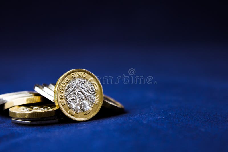 Perth, Scotland - 5 December 2019: One pound coins stacked on a dark background - UK economy stock photo Perth, Scotland - 5 December 2019: One pound coins stacked on a dark background - UK economy stock photo