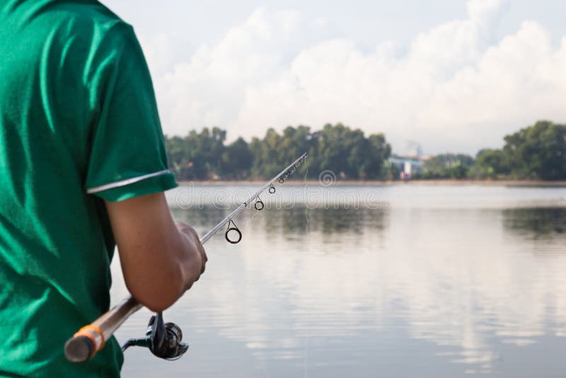 Recreational fishing at a serene lake in a beautiful morning. Recreational fishing at a serene lake in a beautiful morning.