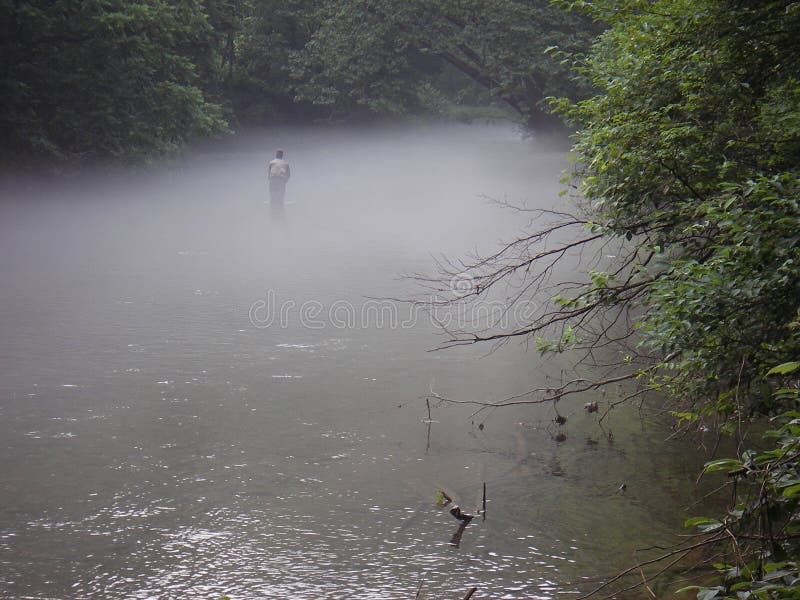 Photo of lone fisherman on the Gunpowder river fishing in foggy summertime conditions. The Gunpowder is a popular tailwater fishery for wild Brown Trout in Maryland. Photo of lone fisherman on the Gunpowder river fishing in foggy summertime conditions. The Gunpowder is a popular tailwater fishery for wild Brown Trout in Maryland.