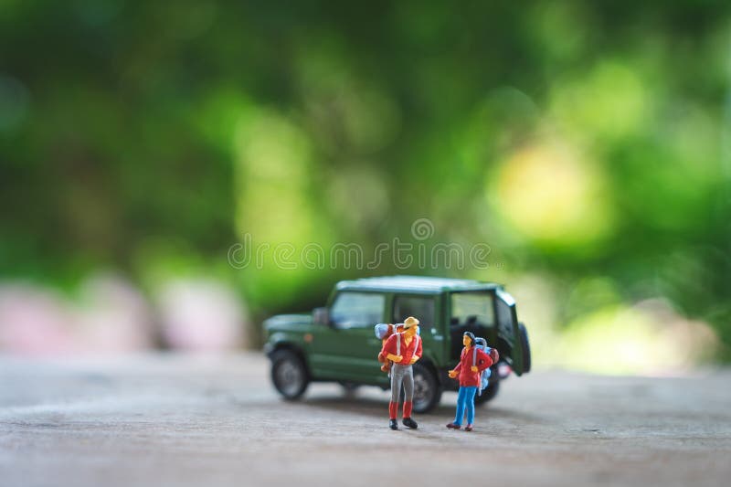 2 pessoas diminutas que estão o planejador do curso com modelo amarelo do carro do brinquedo como o conceito do curso do fundo co foto de stock royalty free 2 pessoas diminutas que estão o planejador do curso com modelo amarelo do carro do brinquedo como o conceito do curso do fundo co foto de stock royalty free