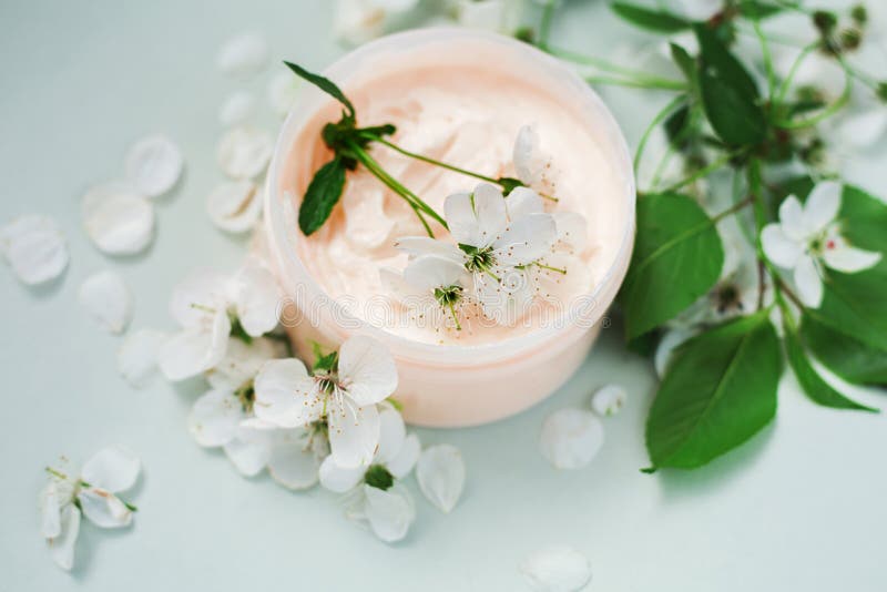 Petalo e un barattolo della crema per il corpo naturale immagine stock Petalo e un barattolo della crema per il corpo naturale immagine stock