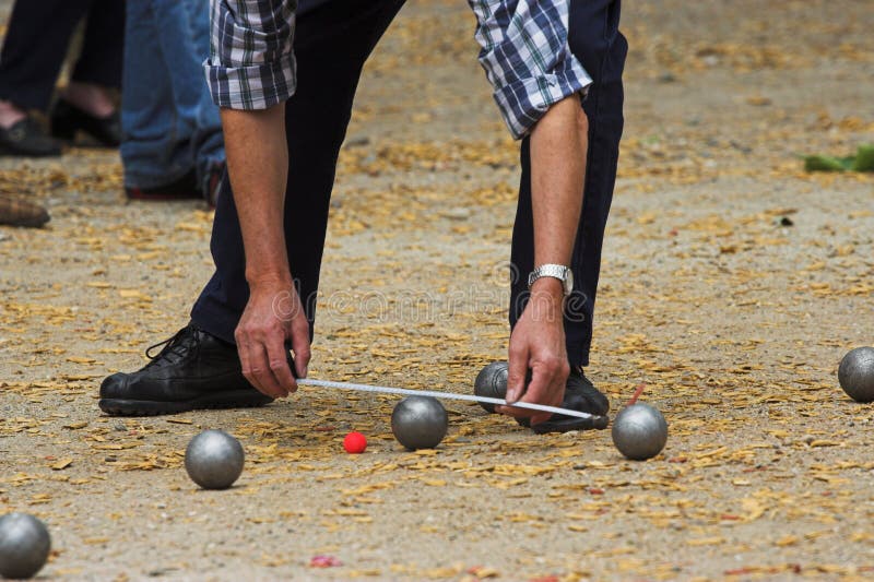 Petanque players in detail editorial photography. Image of fingers