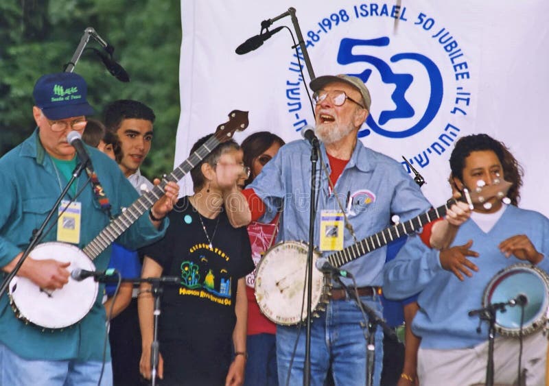 Legendary folk singer and troubadour Pete Seeger leads the singing of â€œTzena, Tzena, Tzena,â€ a song originated by Israeli kibbutzniks, at a celebration of the 50th anniversary of the founding of the state of Israel at the East Meadow of Manhattan's Central Park on June 7, 1998. Seeger was a composer, arranger, lyricist, and accomplished musician strumming his distinctive 5-stringed banjo emblazoned with the words, â€œthis machine surrounds hate and forces surrender.â€ A champion of the working man, and the oppressed, his songs were about social protest, patriotism, and simple tenderness. Among the songs he is associated with are, â€œGoodnight Irene,â€ â€œIf I Had a Hammer,â€ â€œWhere Have All the Flowers Gone,â€ and â€œWaist Deep in the Big Muddy.â€ A key member of the popular group The Weavers, Seeger was blacklisted for 10 years for failure to co-operate with the US House Un-American Activities Sub-Committee which accused him of being a member of the Communist Party in his youth. Years later, fully rehabilitated and beloved, he was given the Kennedy Center Honors. Seeger died in New York City on January 27, 2014 at the age of 94.