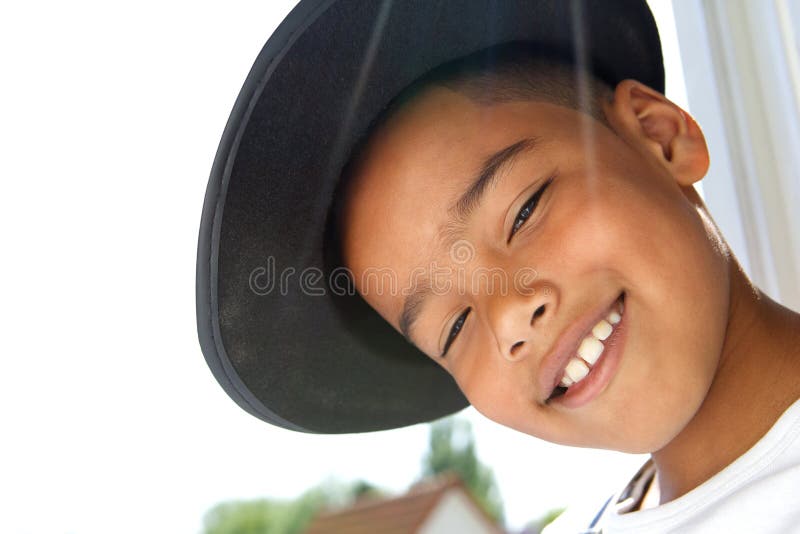 Petit garçon mignon souriant avec le chapeau noir image stock Petit garçon mignon souriant avec le chapeau noir image stock