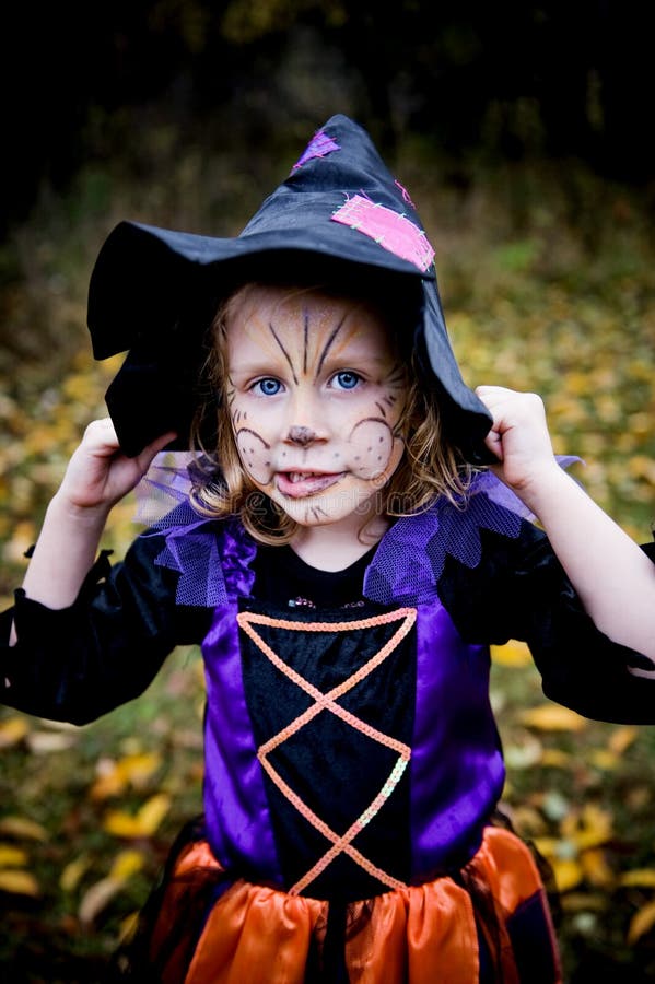 Silly Little Girl in Witch Costume with Face Painted. Silly Little Girl in Witch Costume with Face Painted