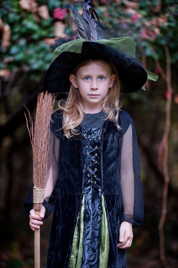 Little Girl in Witch Costume with Broom in Autumn. Little Girl in Witch Costume with Broom in Autumn