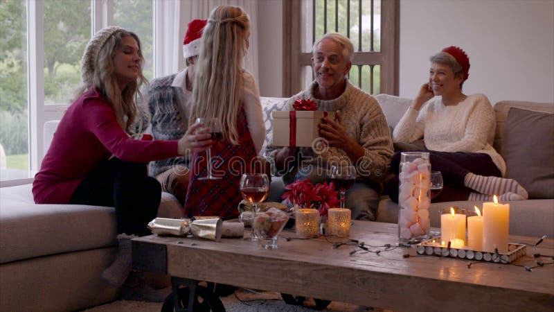 Petite fille donnant le cadeau de Noël à son grand-père