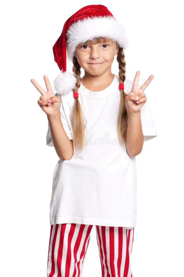 Petite fille heureuse dans le chapeau de Santa image libre de droits Petite fille heureuse dans le chapeau de Santa image libre de droits