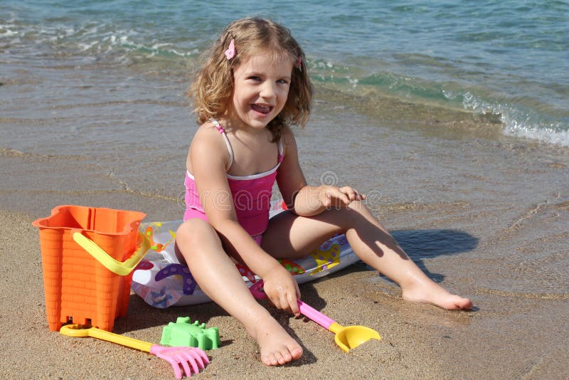 Happy little girl playing on beach. Happy little girl playing on beach