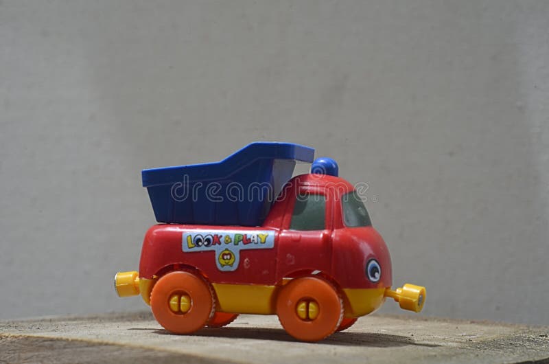 small children's toy car placed on a wooden plank, Yogyakarta, Indonesia. shooting parallel to the height of the object or Eye view angle. small children's toy car placed on a wooden plank, Yogyakarta, Indonesia. shooting parallel to the height of the object or Eye view angle