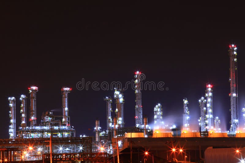 Petrochemical oil refinery plant shines at night, stock photos Petrochemical oil refinery plant shines at night, stock photos