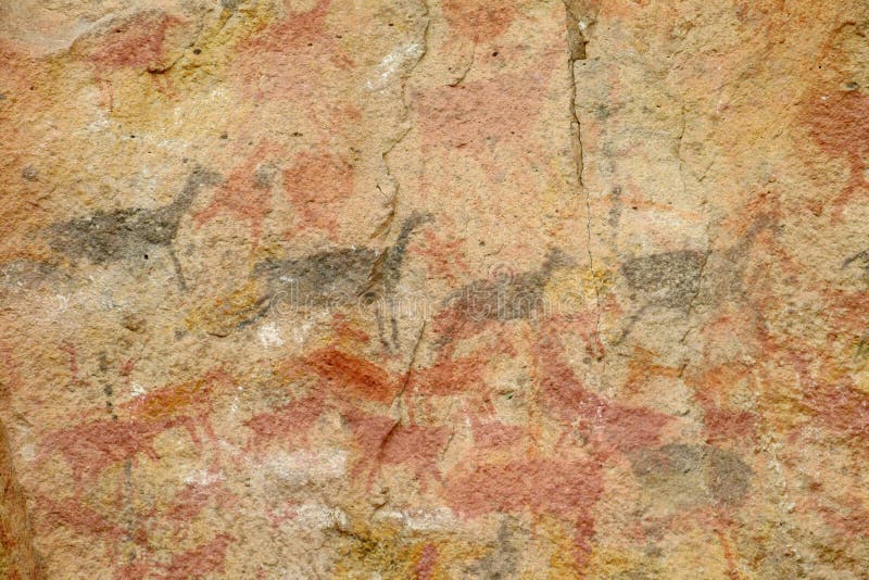 Petroglyphs on a cave wall, Cave of Hands in Argentina, cueva de las manos. Ancient painting made with red, yellow and black colour on the wall of a cave