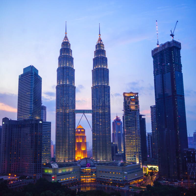 Kuala Lumpur, MALAYSIA - March 26, 2015: Petronas Twin Towers fondly known as KLCC and the surrounding buildings at sunset. Kuala Lumpur, MALAYSIA - March 26, 2015: Petronas Twin Towers fondly known as KLCC and the surrounding buildings at sunset