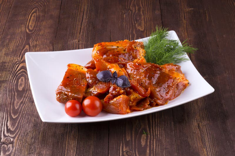 Pezzi di carne di maiale cruda sul piatto bianco Bei pezzi del barbecue con salsa fotografia stock Pezzi di carne di maiale cruda sul piatto bianco Bei pezzi del barbecue con salsa fotografia stock