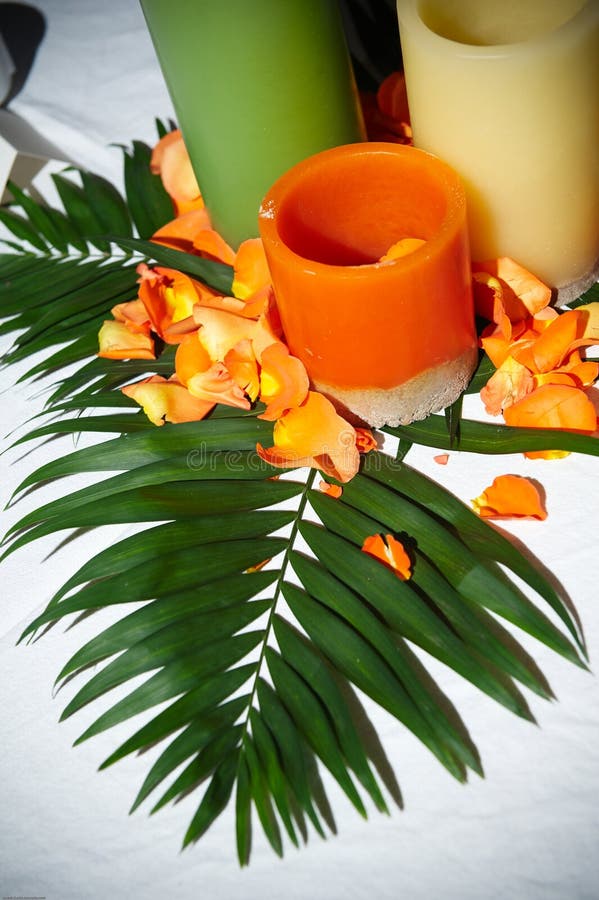 Details of a decorative candle and floral table centerpiece for a tropical wedding. Details of a decorative candle and floral table centerpiece for a tropical wedding.