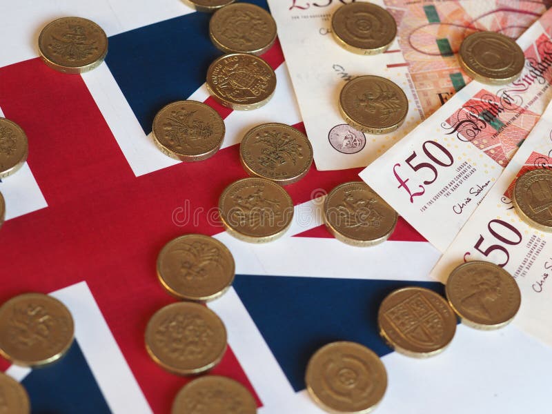 Pfundmünzen und Banknoten, Vereinigtes Königreich über Flagge lizenzfreies stockbild Pfundmünzen und Banknoten, Vereinigtes Königreich über Flagge lizenzfreies stockbild
