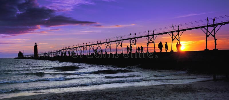 Over one hundred people line the Grand haven Lighthouse pier watching this beautiful sunset. Over one hundred people line the Grand haven Lighthouse pier watching this beautiful sunset.