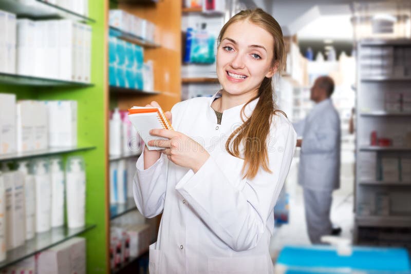 Pharmacist and Assistant Working at Farmacy Reception Stock Photo