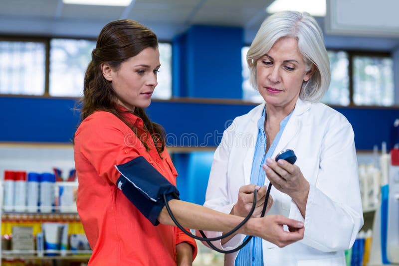 Pharmacist Checking Blood Pressure of Customer Stock Photo Image of