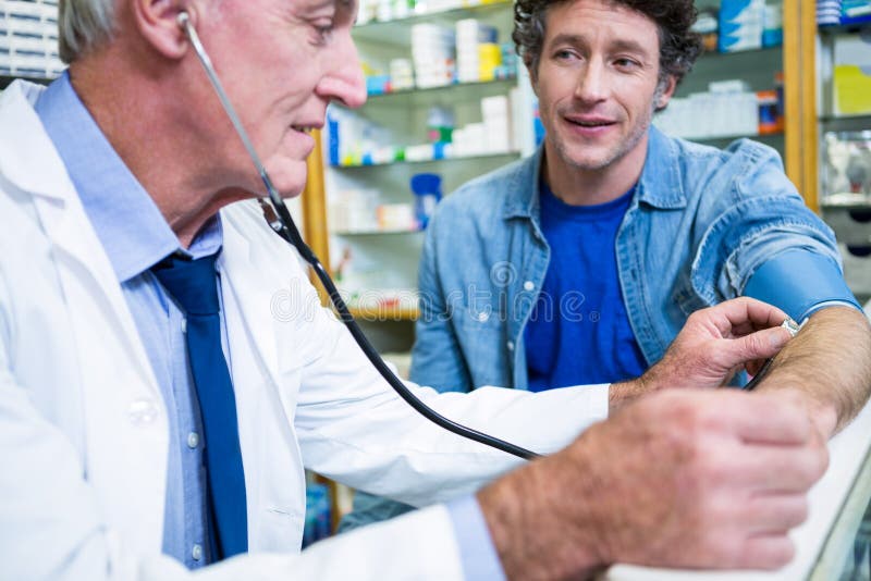 Pharmacist Checking Blood Pressure of Customer Stock Photo Image of