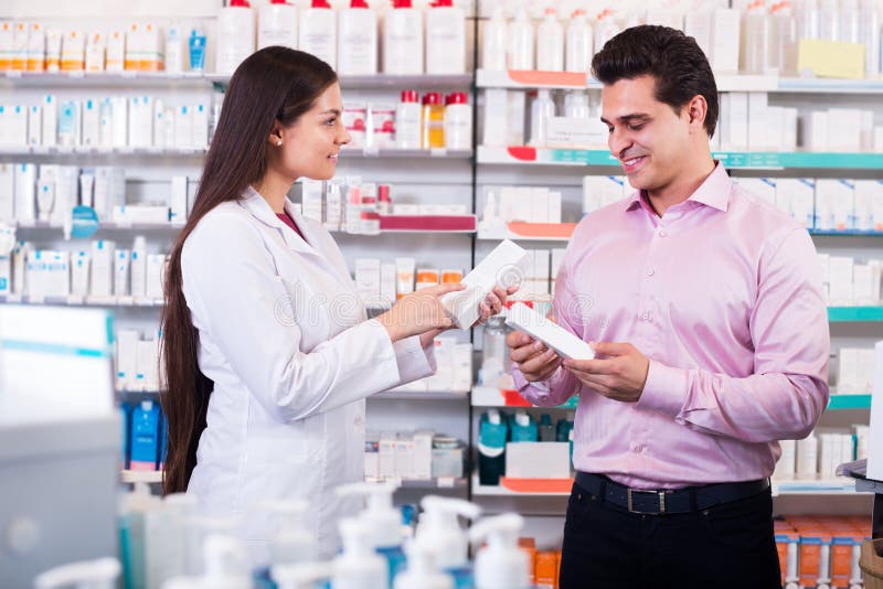Pharmacist and Consulting Man in Pharmacy Stock Photo Image of