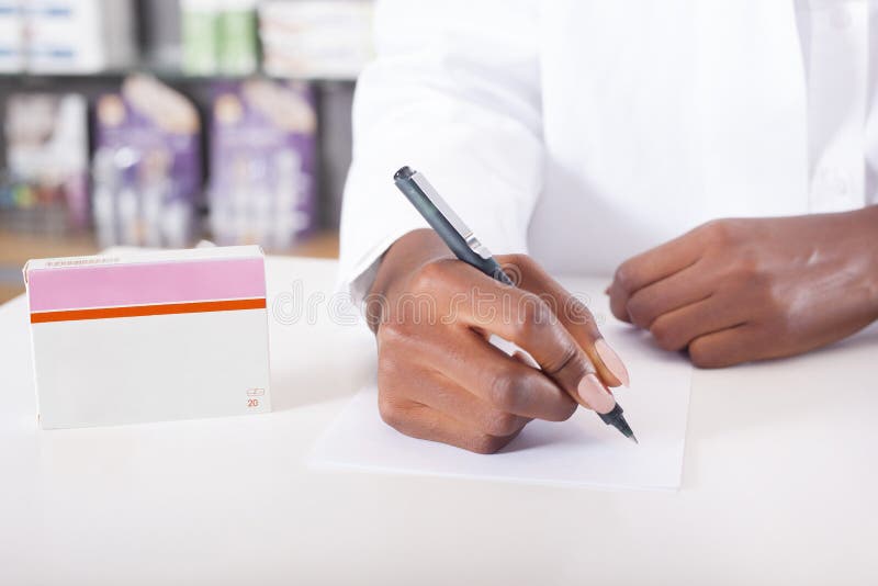 Pharmacist or doctor writing with tablet package with copy space