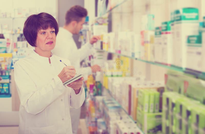 Pharmacist and Pharmacy Technician Posing in Drugstore Stock Image