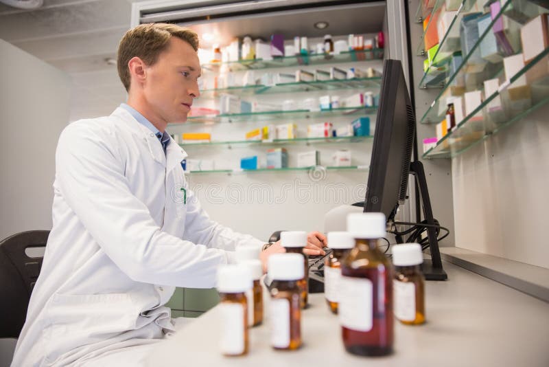Pharmacist Using Computer at Desk Stock Image Image of medicament