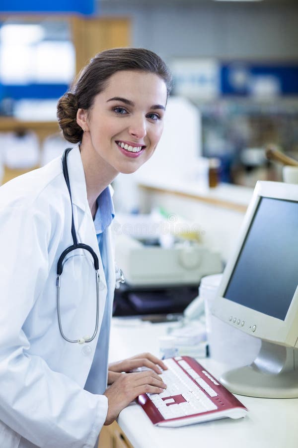 Pharmacist Working on Computer in Pharmacy Stock Image Image of happy