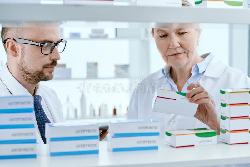 close-up. pharmacists discussing an online order standing near a pharmacy display case.